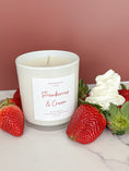 Load image into Gallery viewer, Candle labeled 'Strawberries & Cream' with strawberries and whipped cream on a marble surface.