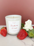 Load image into Gallery viewer, Candle labeled 'Strawberries & Cream' with strawberries and cream on a marble surface.
